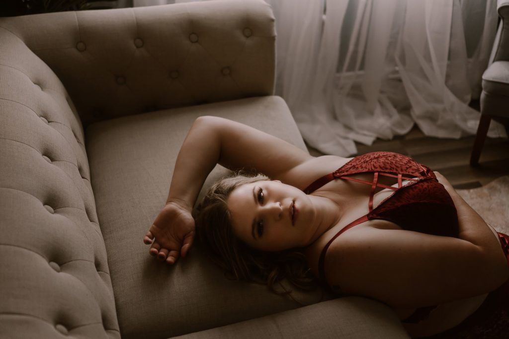 beautiful woman in red invest in yourself with stl boudoir photographer session