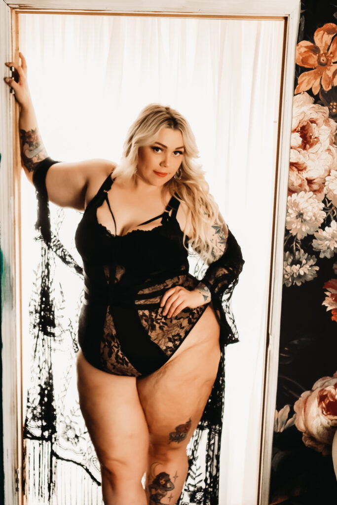 lace black bodysuit / blonde leaning in door way / plus-size boudoir outfits / photo by boudoir by vanessa summers of st. louis, mo. see more at www.stlboudoirphotographer.com/blog